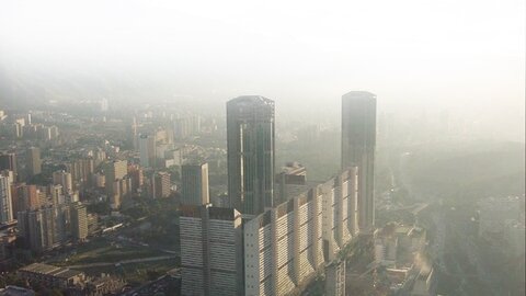 Parque Central twin towers in Caracas, Venezuela - iconic high-rise residential complex with cylindrical and rectangular skyscrapers in misty urban skyline