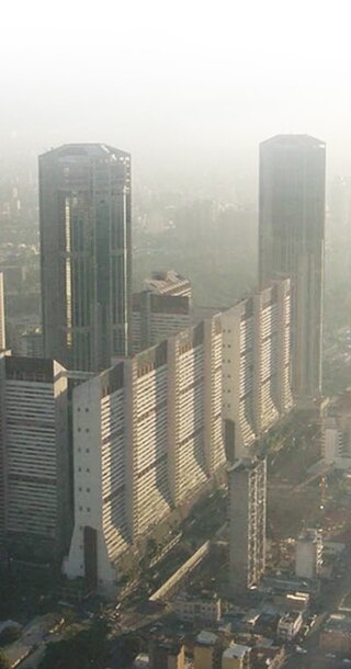 Parque Central twin towers in Caracas, Venezuela - iconic high-rise residential complex with cylindrical and rectangular skyscrapers in misty urban skyline
